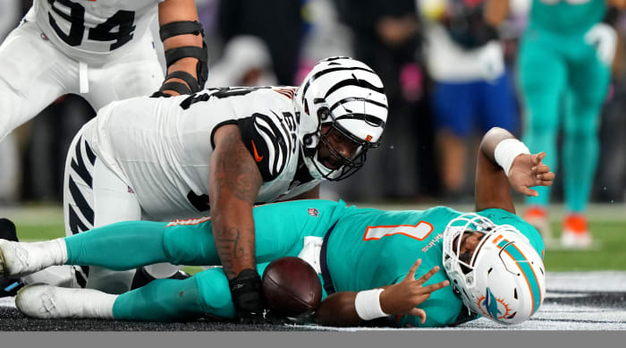 Dolphins quarterback Tua Tagovailoa lies on the ground after being sacked by Bengals defensive tackle Josh Tupou. Tagovailoa sustained a concussion on the play.